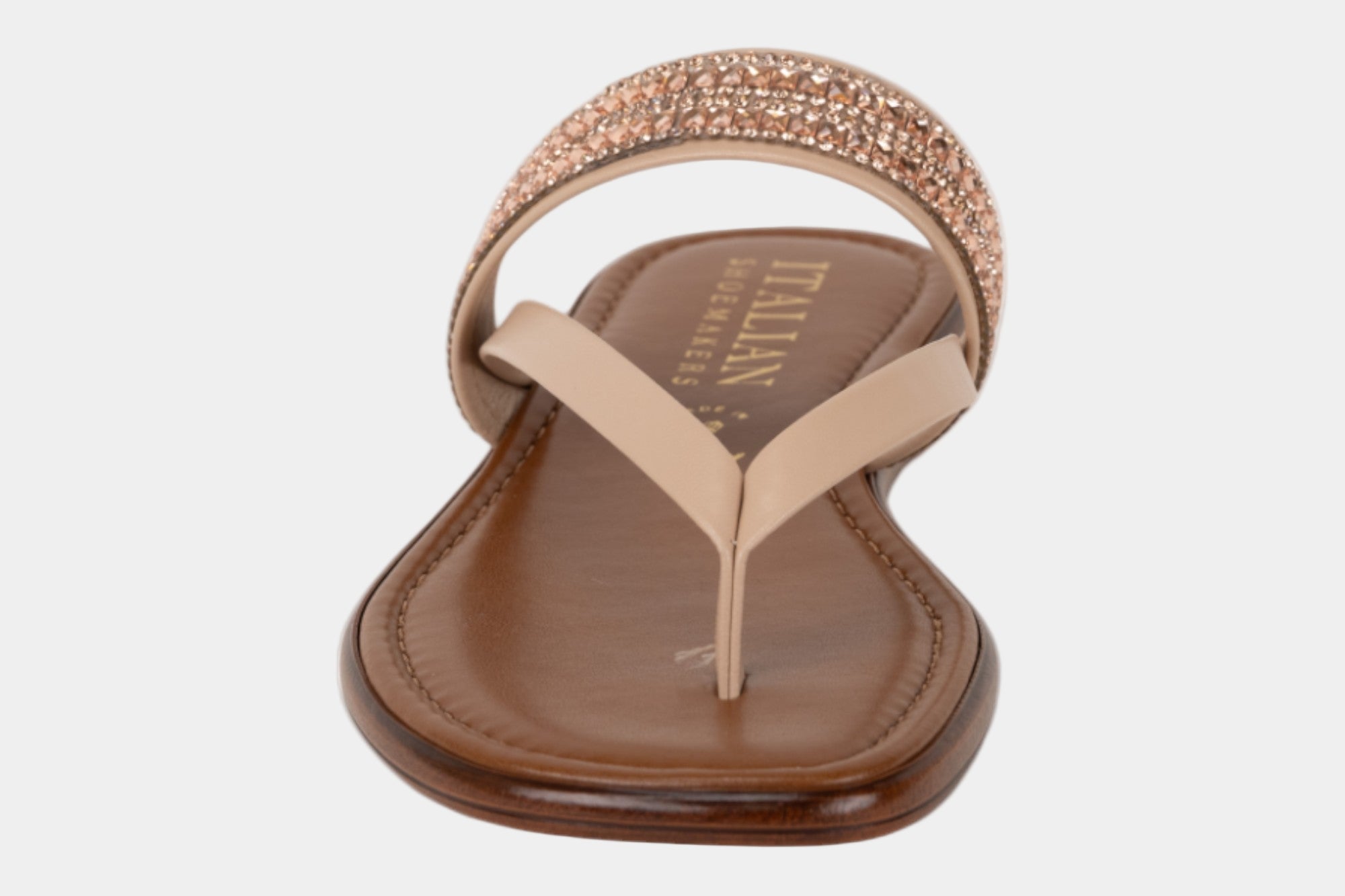 Beige sandal with rhinestone embellishments on a white background