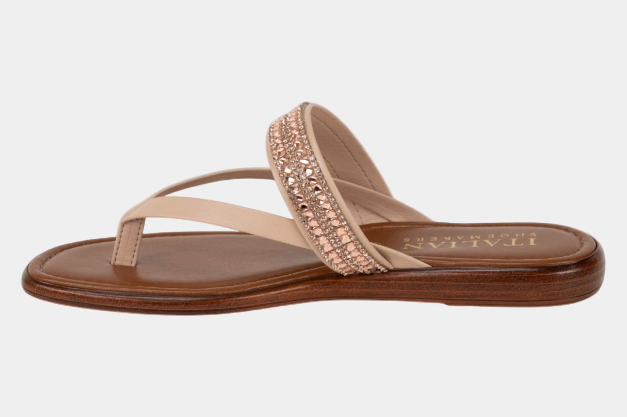 Beige sandal with brown sole on a white background